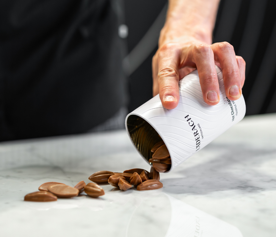 Adding chocolate drops to warm milk and stirring